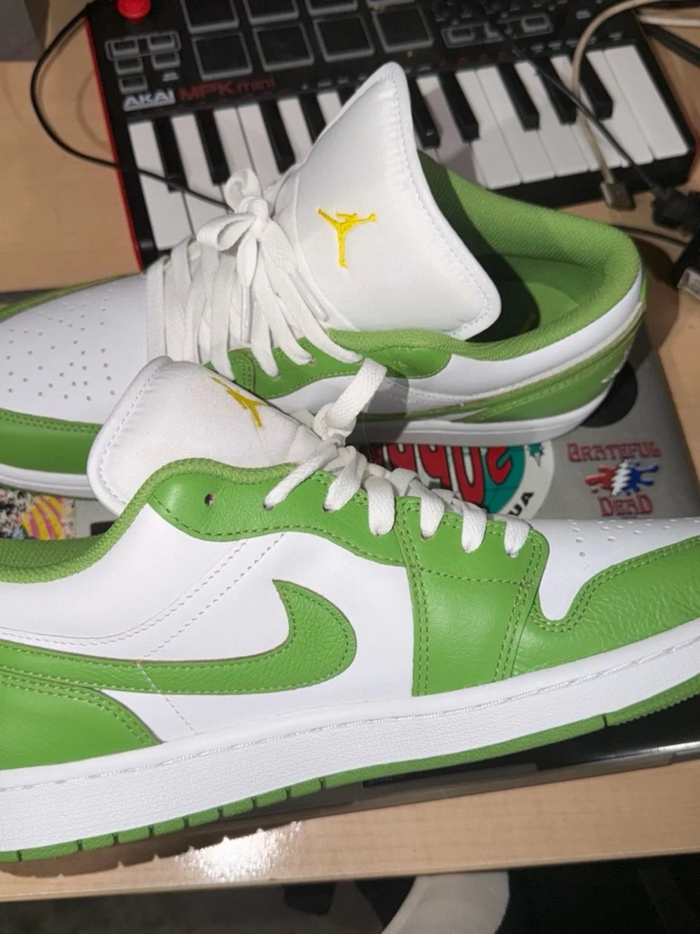 Nike Jordan 1  SE White and Green Low-Top Sneakers with Yellow Logo